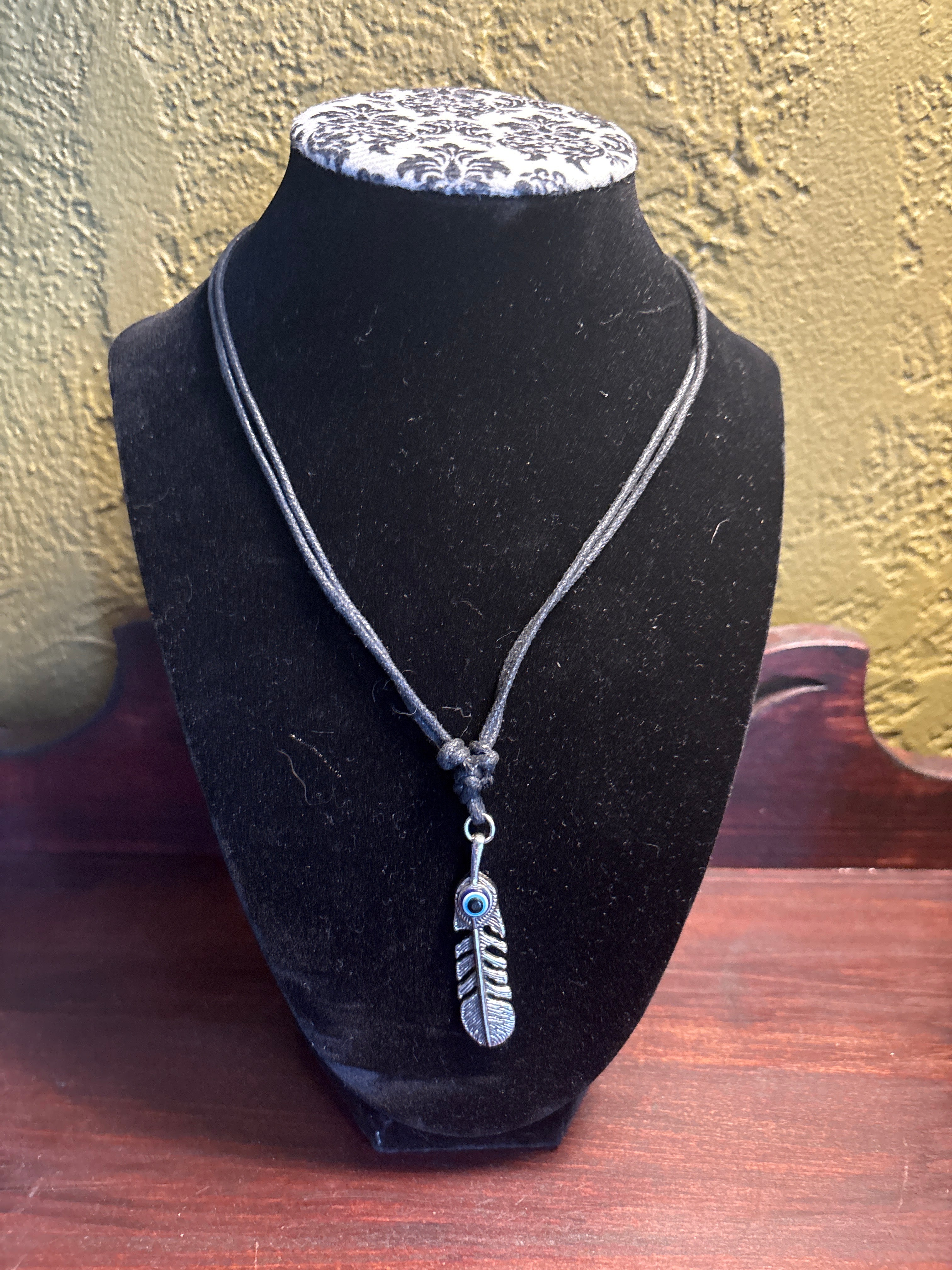 Evil eye feather on adjustable rope