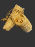 Two natural loofah sponges tied together on a gray background