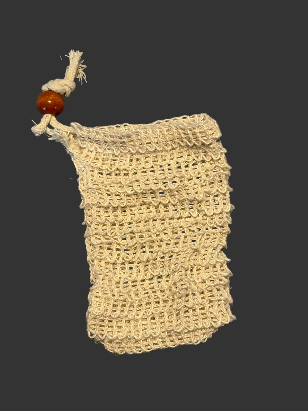 Beige woven soap bag with a wooden bead on a black background